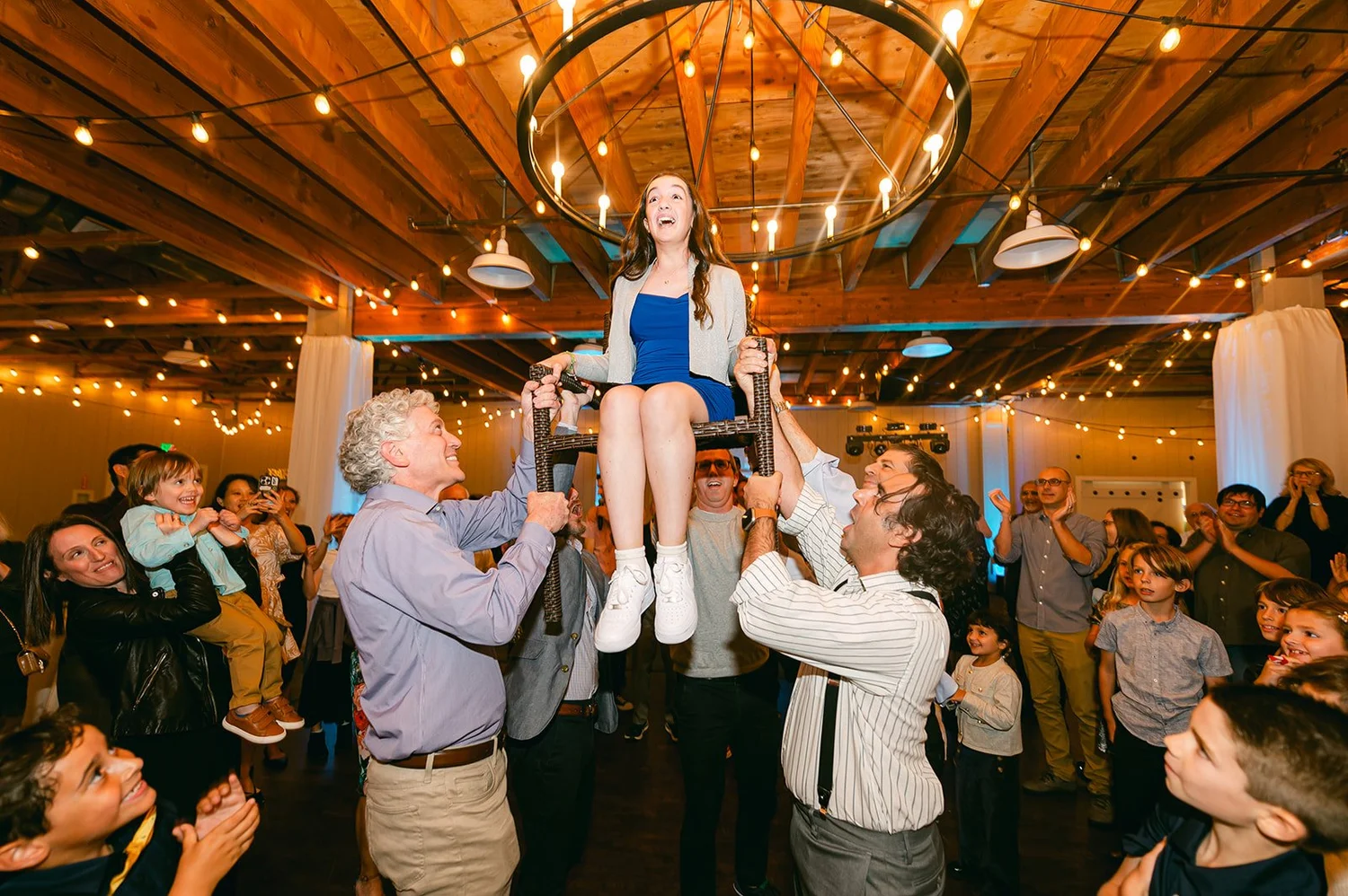 Bat Mitzvah lifted in a chair during the Hora dance at Strawberry Farms in Irvine CA